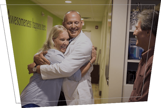 Dentist hugging dental patient